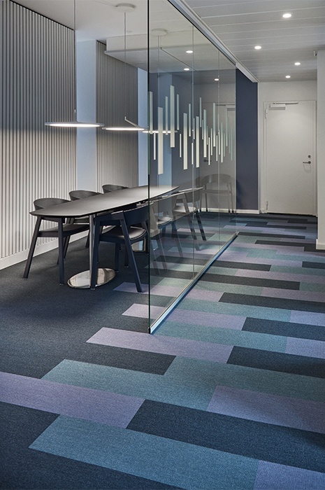 Teppich Design Trends: Verschiedenfarbige Teppichplanken im Meetingraum