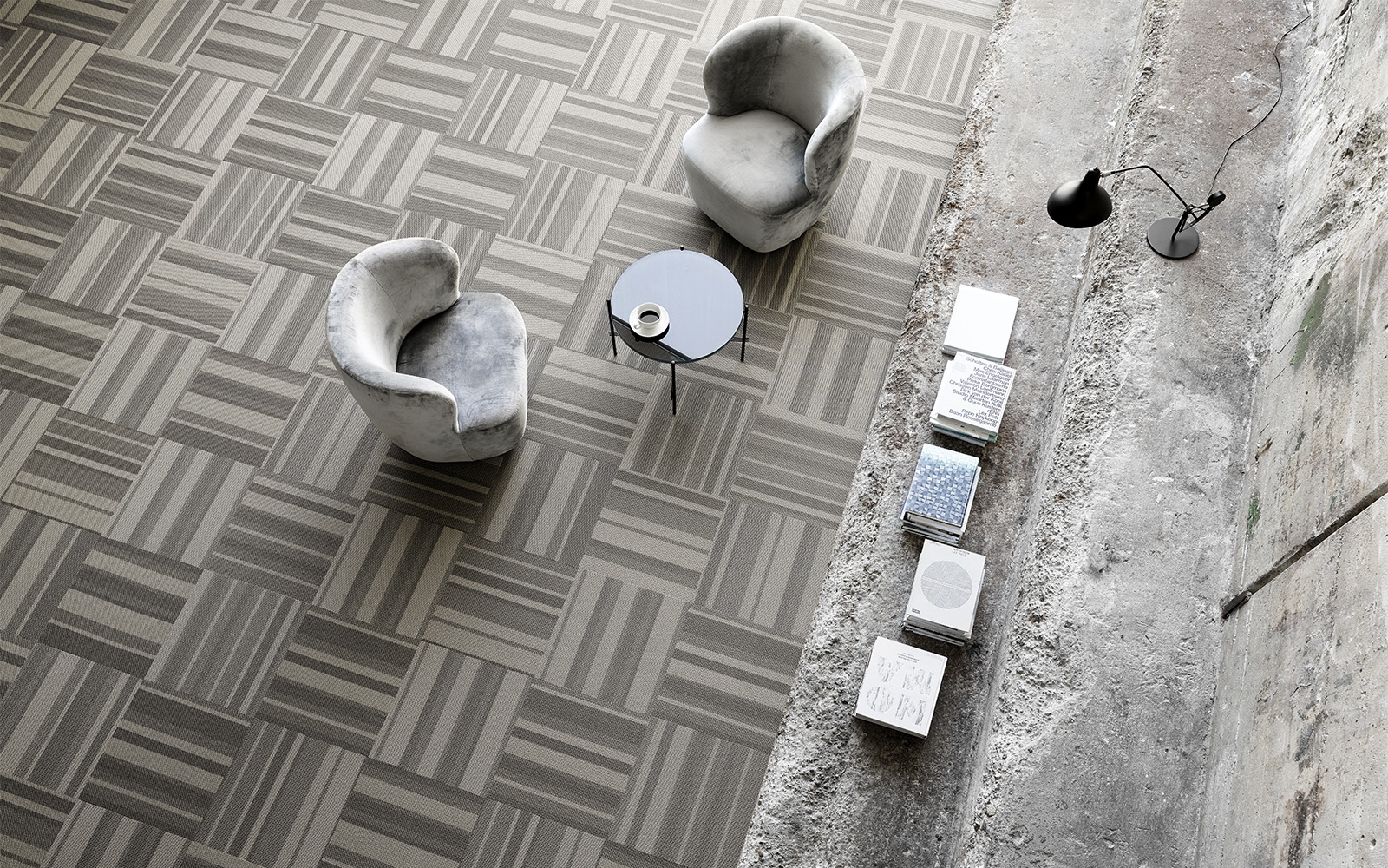 Two chairs in a plain setting room with grey striped carpet tiles Two chairs in a plain setting room with grey striped carpet tiles