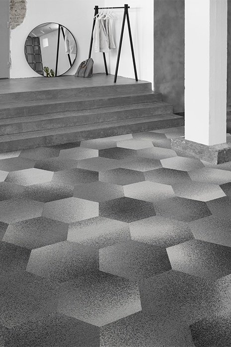 Custom designed hexagon shaped carpet tiles leading up a short staircase to a round mirror Custom designed hexagon shaped carpet tiles leading up a short staircase to a round mirror